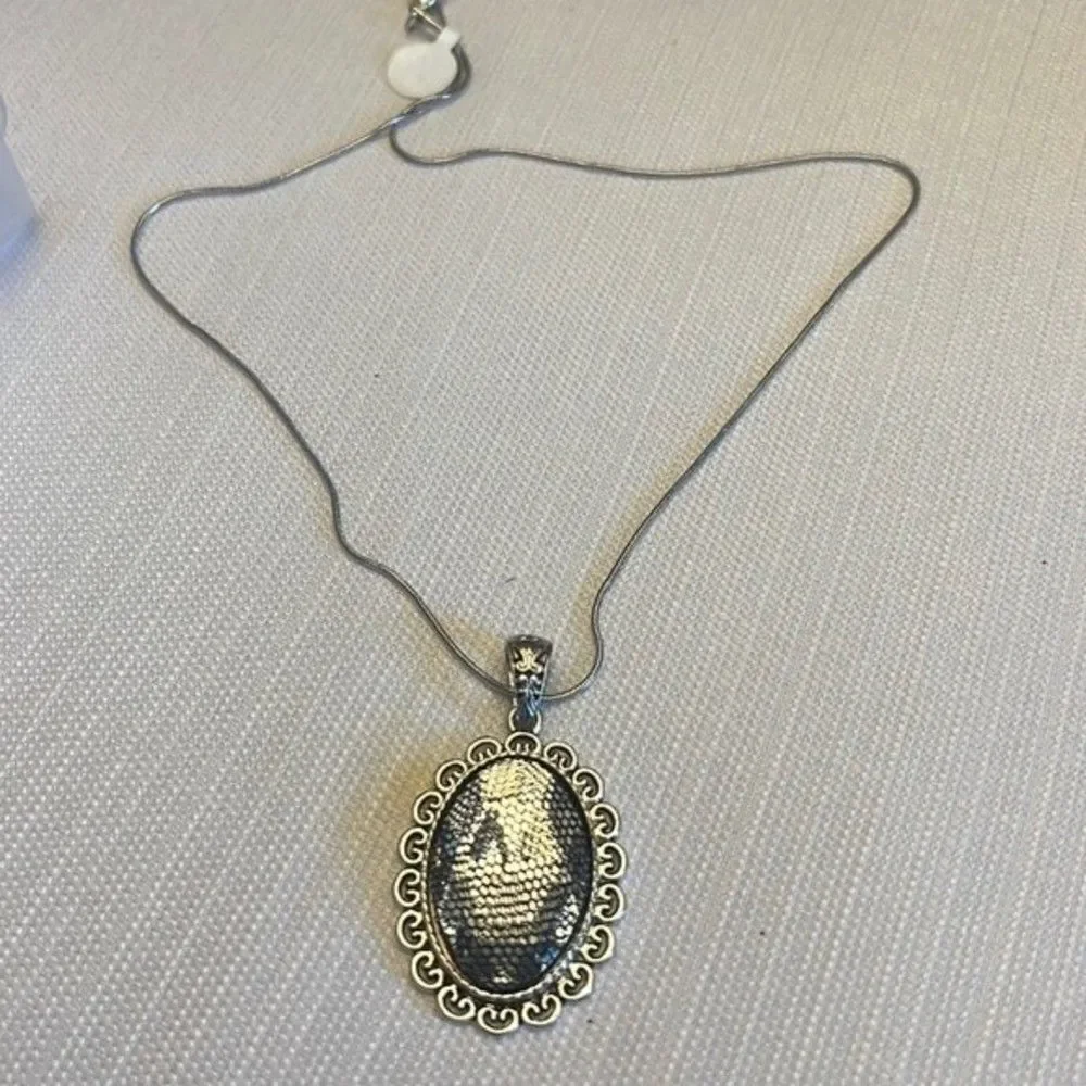 Handcrafted clear stone pendant with mesh overlay on silver tone chain